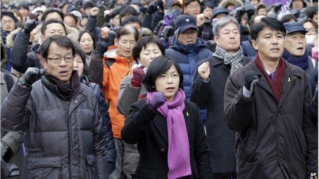 Lee Jung-hee, centre, a head of the Unified Progressive Party, and supporters shout slogans against constitutional court's verdict near the constitutional court in Seoul, South Korea, Friday, 19 December 2014