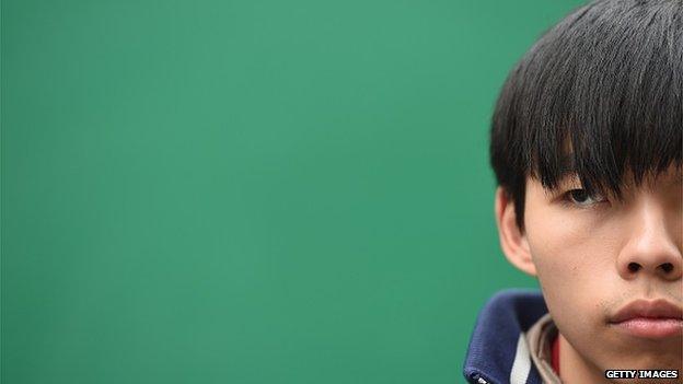 Joshua Wong, the teenage face of Hong Kong's pro-democracy movement, looks on before speaking at the movement's main protest site in the Admiralty district of Hong Kong on 3 December, 2014