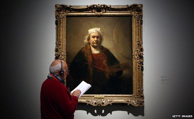A visitor views a painting by Dutch artist Rembrandt entitled "Self Portrait with Two Circles" during a press preview at the National Gallery on October 14, 2014 in London, England