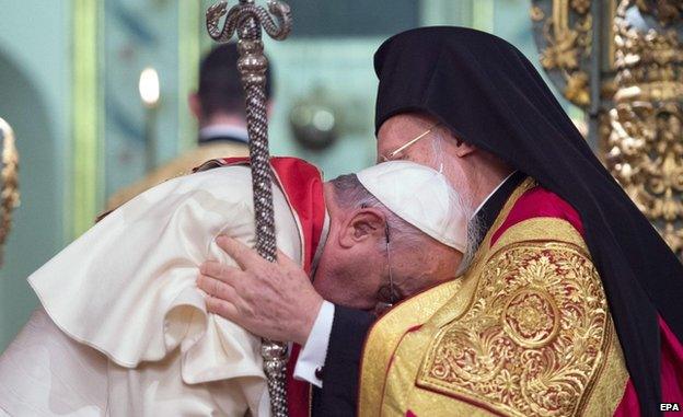 Pope Francis (L) is embraced by Ecumenical Orthodox Patriarch Bartholomew I (R) in Turkey