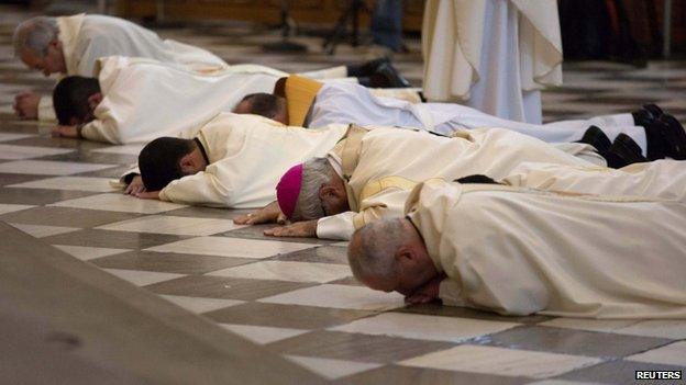 Archbishop of Granada Francisco Javier Martinez and priests prostrate in front of the altar in Granada in Spain to seek pardon over sexual abuse allegations (Nov 2014)