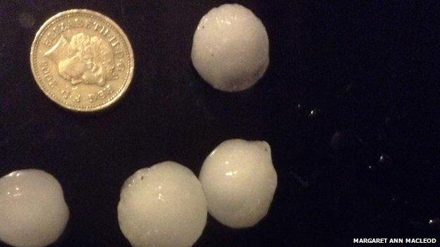 Ness hailstones next to a £1 coin