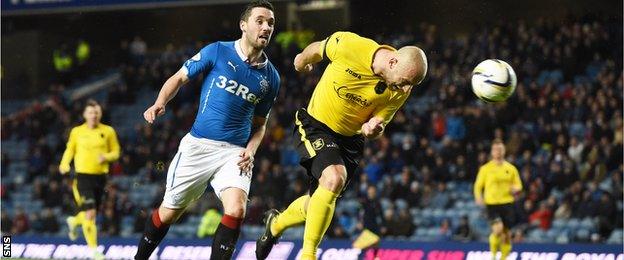 Livingston's Simon Mensing scores an own goal in the match against Rangers