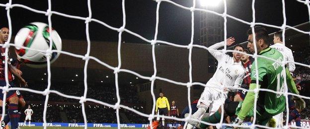 Real Madrid defender Sergio Ramos heads his side in front against San Lorenzo