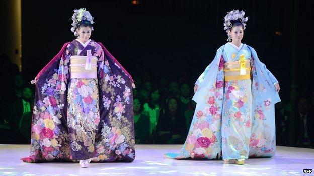 Models wearing bridal kimonos at a fashion show