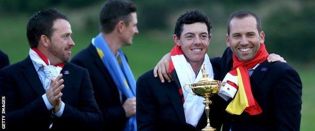 Rory McIlroy and Sergio Garcia pose with the 2014 Ryder Cup trophy