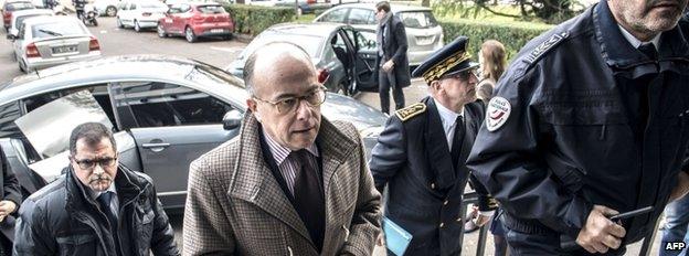 French Interior Minister Bernard Cazeneuve (C) arrives at a police station in Dijon, eastern France, 22 December