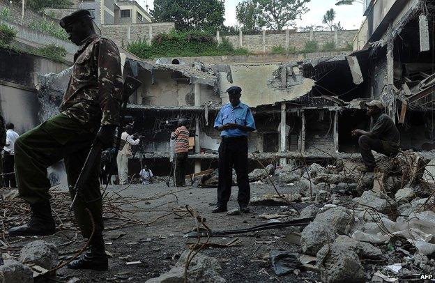 A soldier stands guard during a tour, on January 21, 2014, of the destroyed Westgate mall in Nairobi