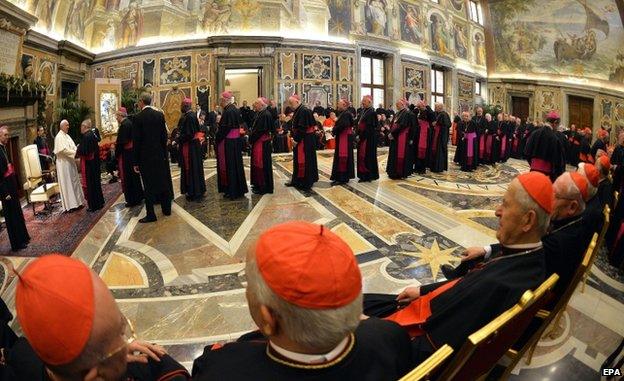 Pope Francis (L) greets cardinals at the end of the Curia audience (22 Dec)