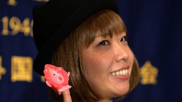 This file picture taken on 24 July 2014 shows Japanese artist Megumi Igarashi showing a small mascot shaped like a vagina "Manko-chan" at a news conference in Tokyo.