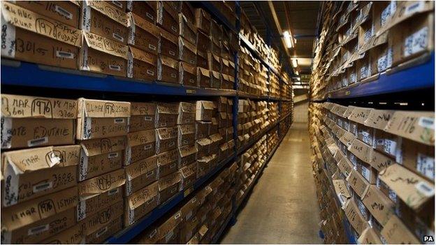 Stacks of boxes on shelves in a warehouse