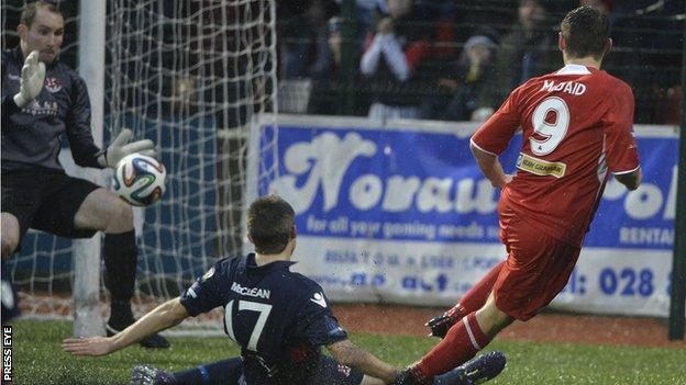 Crusaders keeper Sean O'Neill keeps out this shot from Cliftonville forward David McDaid