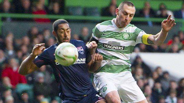 Ross County's Jamie Reckord and Celtic's Scott Brown battle for the ball.