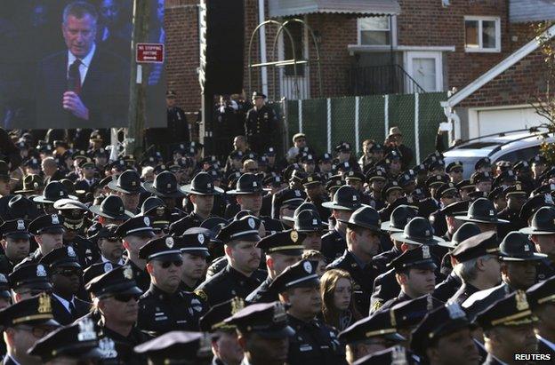 Officers turn their backs on Mayor Bill de Blasio outside the church in New York, 27 December