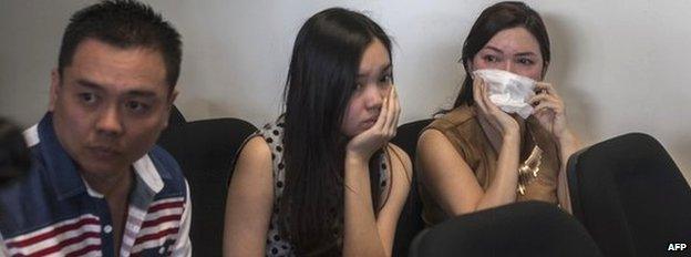 Anxious family members wait for news at the airport in Surabaya