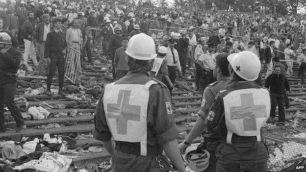 Rescuers attend victims at Heysel football stadium in Brussels on 29 May 1985