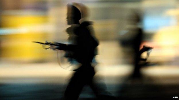 In this photograph taken on November 28, 2008, Indian Army soldiers run to take their positions outside the Taj Mahal Hotel in Mumbai, during an attack by suspected militants