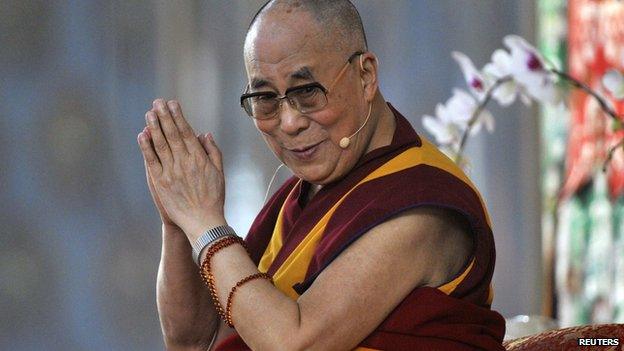 Exiled Tibetan spiritual leader, the Dalai Lama, gestures as he speaks to his followers during the Jangchup Lamrim teaching session at the Gaden Jangtse Thoesam Norling Monastery in Mundgod in the southern Indian state of Karnataka on 23 December, 2014