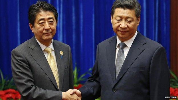 China's Xi Jinping shakes hands with Japanese Prime Minister Shinzo Abe during their meeting at the Great Hall of the People, on the sidelines of the Asia Pacific Economic Cooperation (APEC) meetings, in Beijing in this 10 November, 2014 file photo