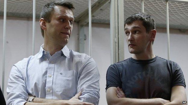 Russian opposition activist and anti-corruption crusader Alexei Navalny, 38, left, and his brother Oleg Navalny stand at a court in Moscow, Russia, Tuesday, Dec. 30, 2014