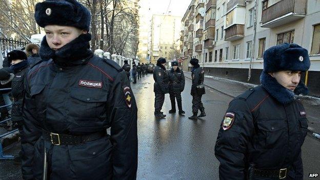 Russian police outside a court building in Moscow where Alexei and Oleg Navalny were sentenced on 30 December 2014