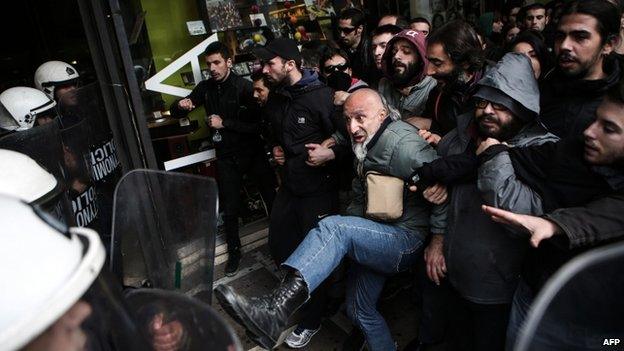 Protesters clash with riot police over the government's decision to relax Sunday shopping laws