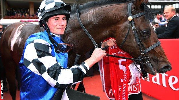 Jockey Ryan Moore celebrates after winning on Protectionist in race 7 the Emirates Melbourne Cup on Melbourne Cup Day at Flemington Racecourse on November 4, 2014