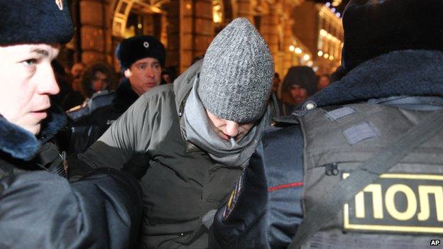 Police officers detain Russian opposition activist and anti-corruption crusader Alexei Navalny, 38, centre, on his way to attend a rally in Manezh Square in Moscow, Russia, Tuesday, Dec. 30,