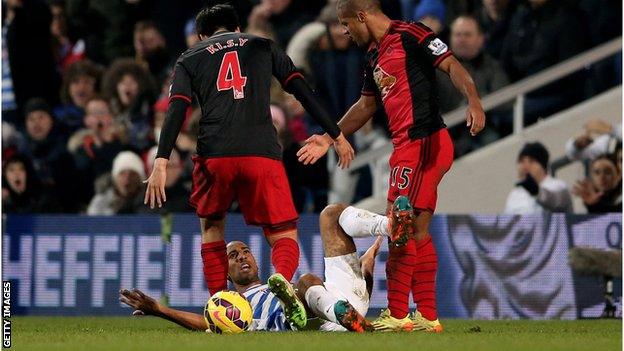 Karl Henry of QPR clashes with Swansea City pair Ki Sung-Yueng and Wayne Routledge