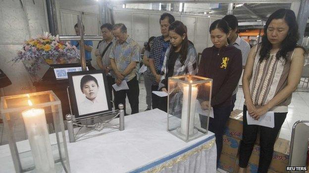 Family members of Grayson Herbert Linaksita, a passenger of AirAsia Flight QZ8501, attend his cremation at The Adijasa crematorium in Surabaya