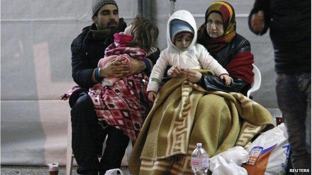 Migrants rest after disembarking from the Ezadeen, 3 January 2015