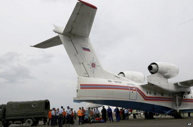 Russian emergency workers unload their equipment from a Beriev Be-200 amphibious aircraft at Pangkalan Bun Airport, Indonesia, 3 January