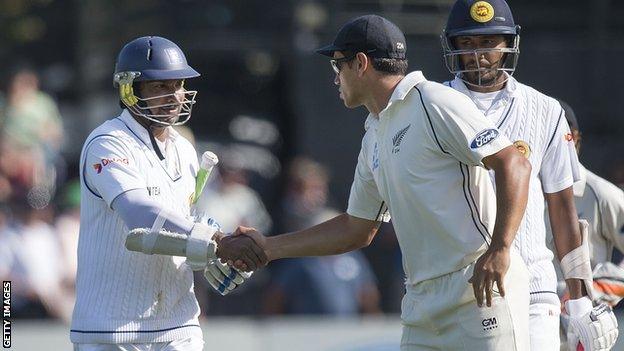 Sri Lanka batsman Kumar Sangakkara is congratulated by New Zealand's Ross Taylor following his dismissal for 203