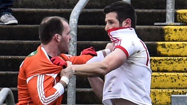 Armagh's Ciaran McKeever and Tyrone's Sean Cavanagh tangle in the first half at the Athletic Grounds