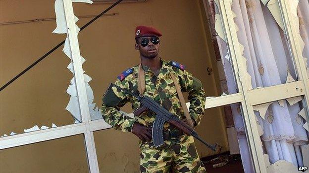 A Burkinabe soldier stands guard outside the national television headquarters after gunshots were fired around the premises in Ouagadougou on 2 November 2014