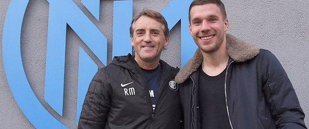 Roberto Mancini and Lukas Podolski