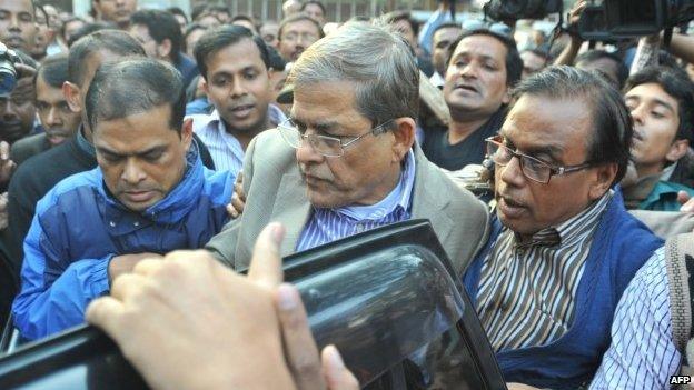 Fakhrul Islam Alamgir (centre), secretary general of the Bangladesh Nationalist Party (BNP), is escorted following his arrest in Dhaka (06 January 2015)