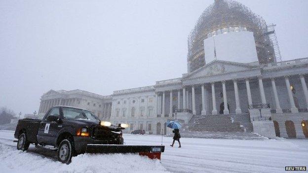 A light snow blankets the east front of the US Capitol 6 January 2015