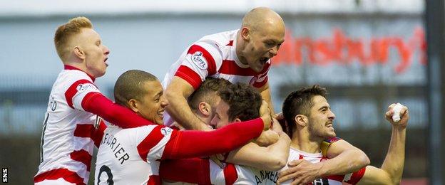 Player-manager Alex Neil is top of the pile as the Accies celebrate Tony Andreu's goal against Dundee in a 2-1 win in December