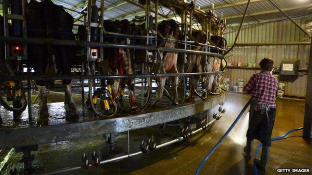 Farmhand Michael Beasy hoses down the milkhouse floor at Pearson's Farm north of Moama, New South Wales, Australia, on Thursday, April 18, 2013