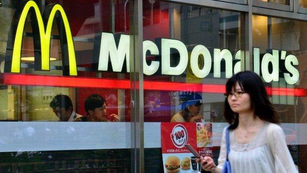 A pedestrian passes before a McDonald's restaurant in Tokyo on July 23, 2014