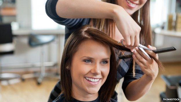 A woman having her hair cut