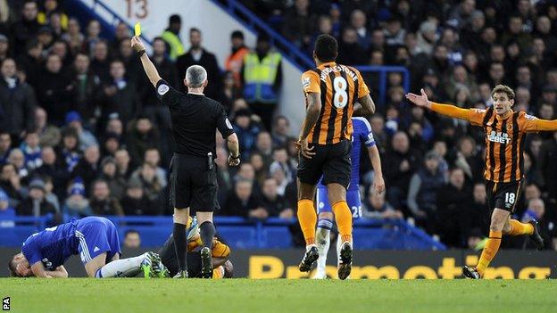 Chris Foy shows Chelsea defender Gary Cahill a yellow card against Hull