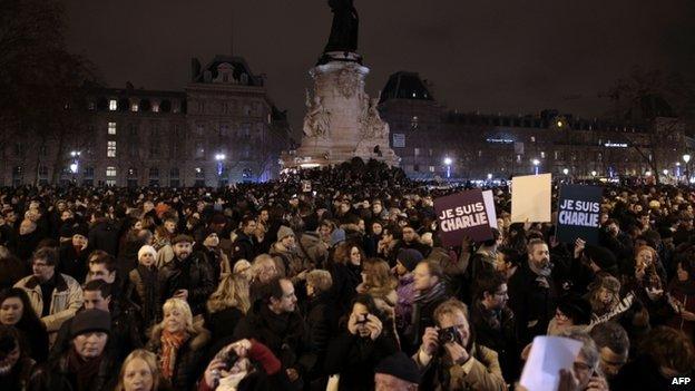 People hold placards reading in French "I am Charlie" during a gathering at the Place de la Republique (Republic square) in Paris, on 7 January 2015,