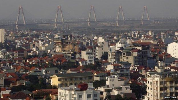 A construction site of Nhat Tan bridge which connects the city to Noi Bai airport is seen from the top of a building in Hanoi December 18, 2014.