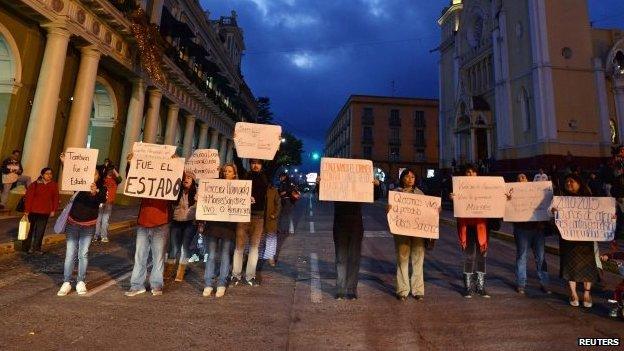 Journalists hold signs demanding the safe return of colleague Moises Sanchez during a protest in Xalapa on 7 January 7, 2015.