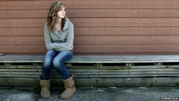 Lonely girl on bench