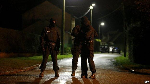 Police officers control cars at check points during the manhunt for the suspects in the shooting attack at the satirical French magazine Charlie Hebdo headquarters on 7 January, in Longpont