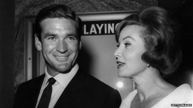 Rod Taylor and actress Rhonda Fleming leaving the premiere of 'Lolita' at LA's Beverly Theatre in 1960