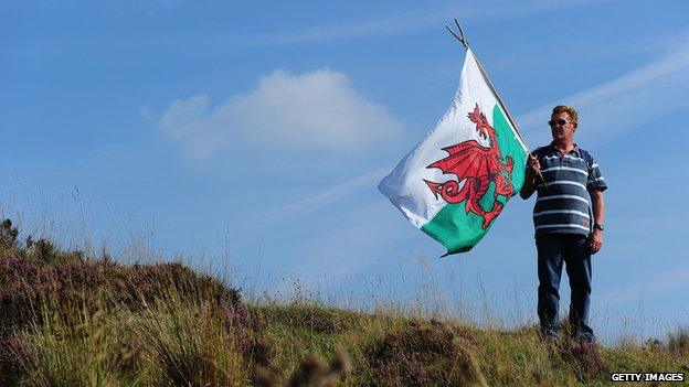 A man holding a welsh flag